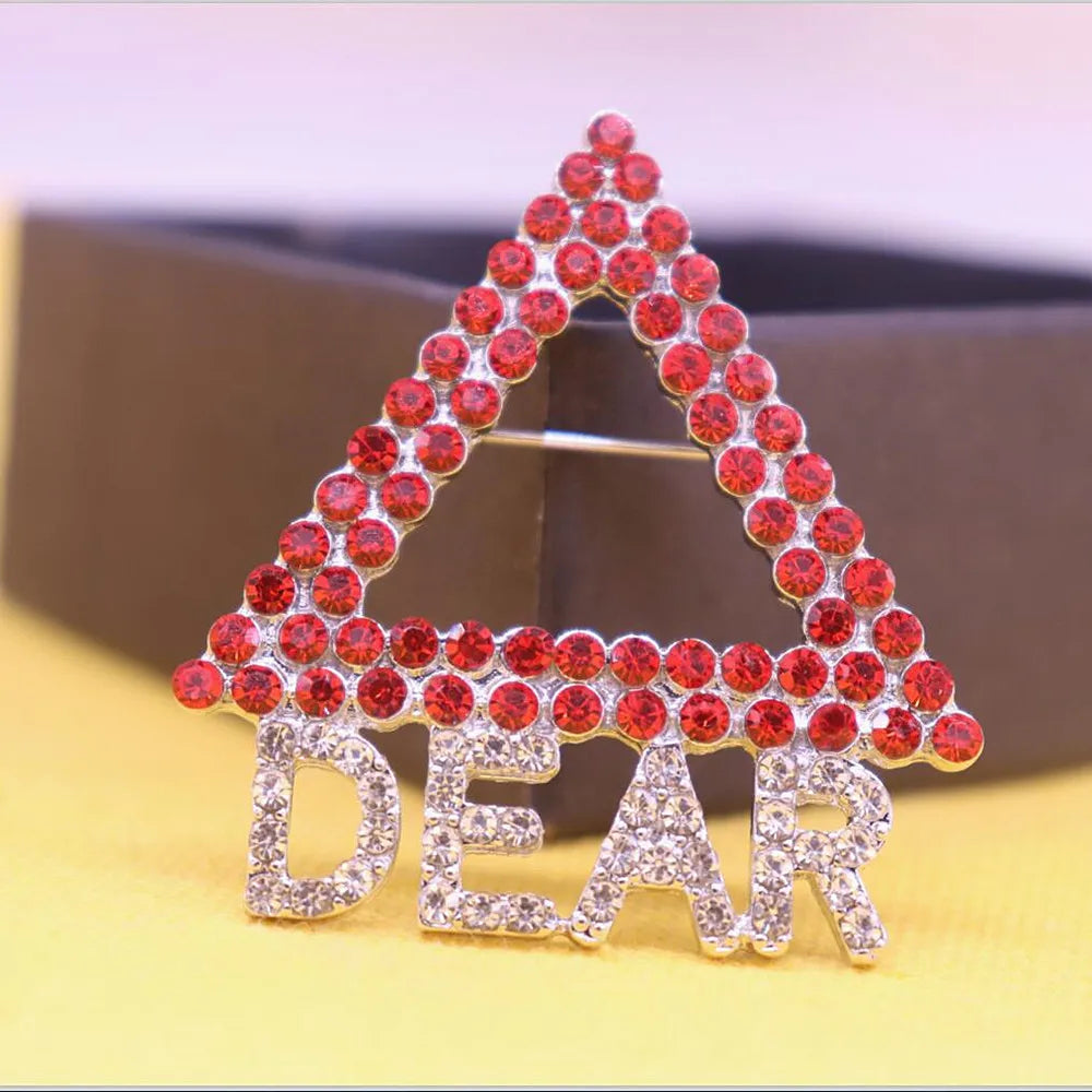 Delta Dear pyramid brooch with crimson and cream stones, perfect for Delta Sigma Theta sorority members. Celebrate Delta pride with sorority paraphernalia.