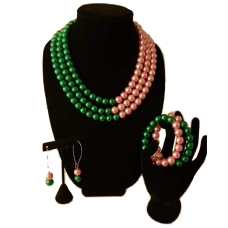 Alpha Kappa Alpha-inspired pink and green pearl necklace, bracelet, and earring set.