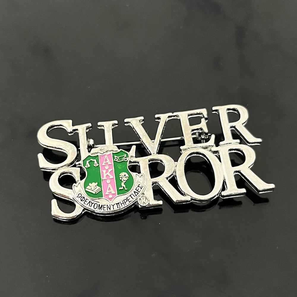 Silver Soror brooch with Alpha Kappa Alpha sorority crest for celebrating years of service and black sorority paraphernalia.