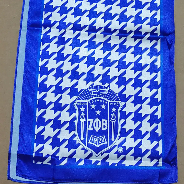 Stylish Zeta Phi Beta scarf featuring blue houndstooth pattern and sorority emblem, perfect for Greek gear enthusiasts.