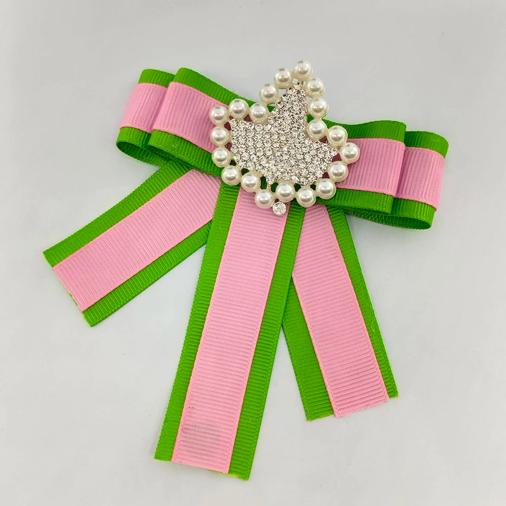 AKA Ivy and Pearl Ribbon Brooch in pink and green, perfect sorority paraphernalia for Alpha Kappa Alpha, featuring elegant pearls and vibrant colors.