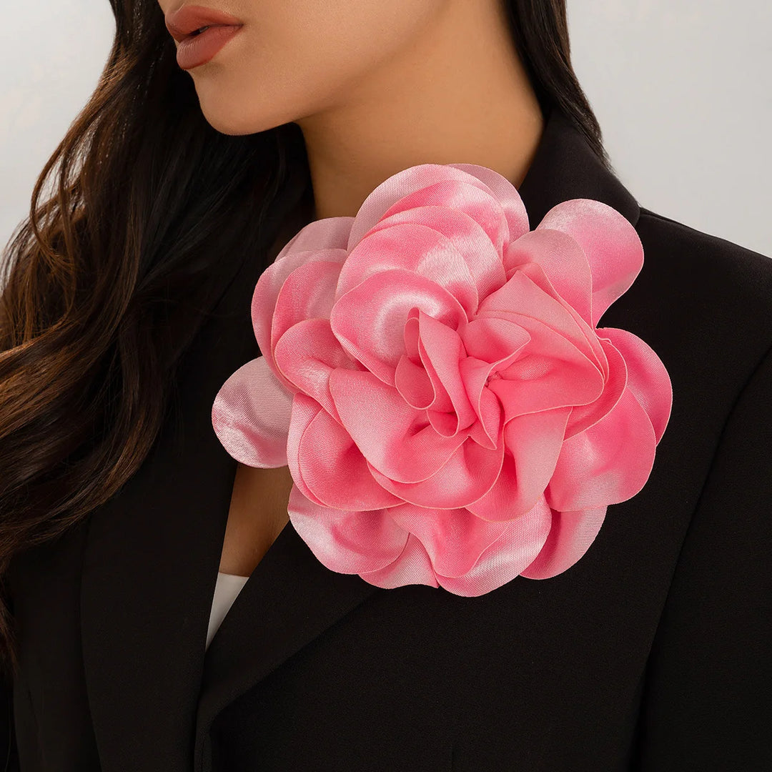 Woman wearing pink flower brooch, a perfect sorority accessory for black greek lettered organizations, including alpha kappa alpha and others.