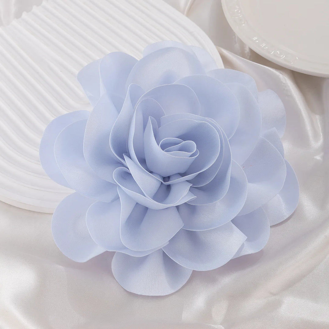 Light blue sorority flower brooch on white fabric, perfect sorority paraphernalia for black greek lettered organizations and sorority apparel.