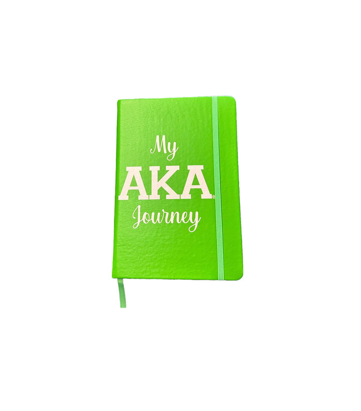 Bright green AKA journal with the title "My AKA Journey," perfect for sorority and fraternity paraphernalia, featuring lined pages and a ribbon marker.